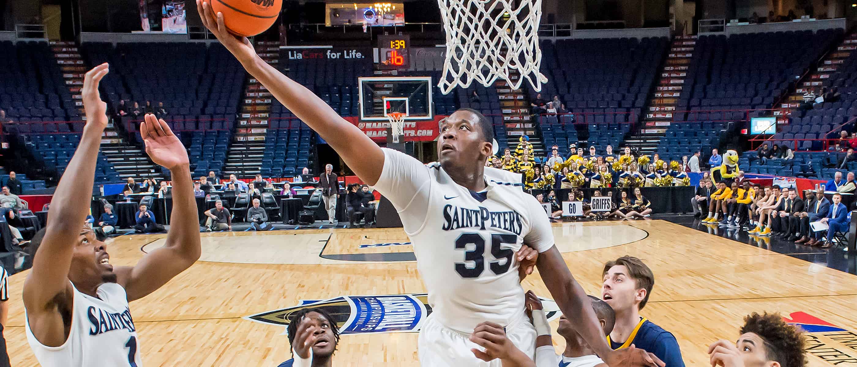 Men's basketball player going to the rim for a layup