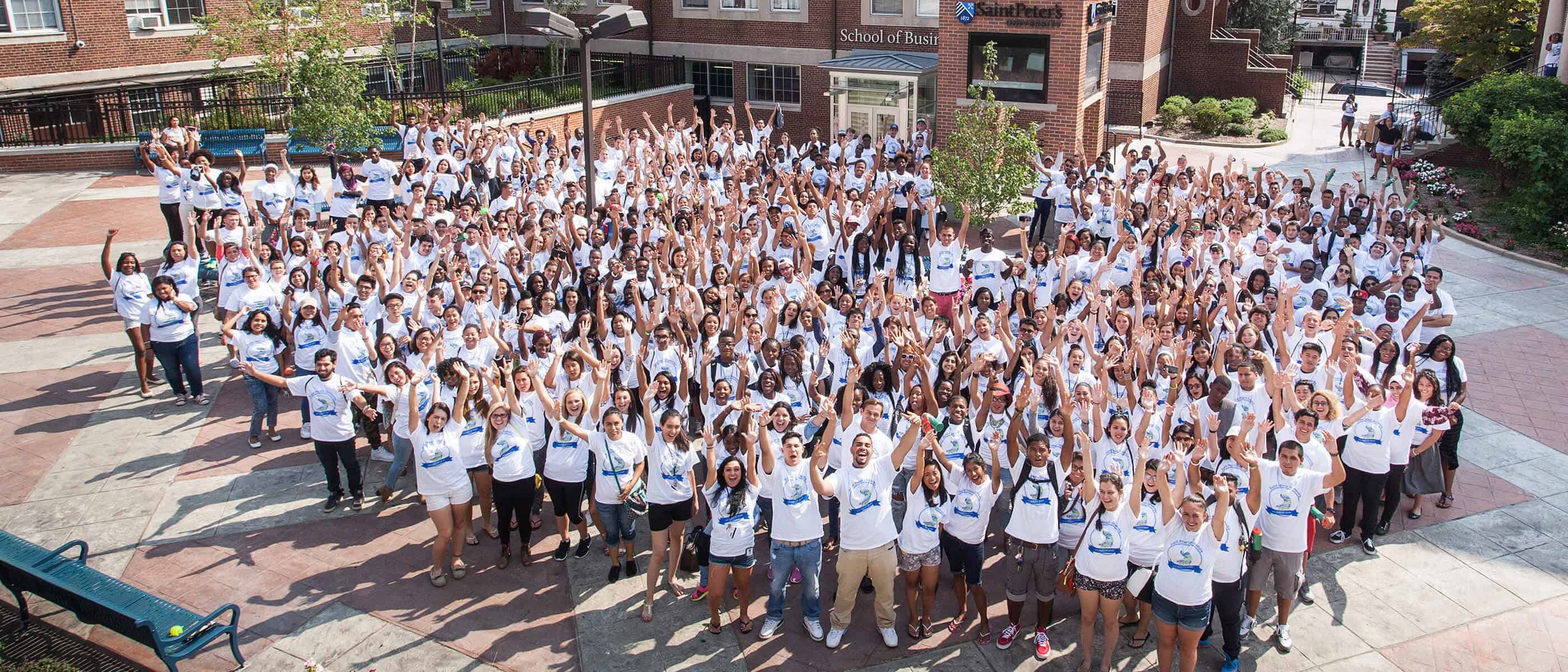 the Saint Peter's community celebrating in a group in the quad