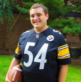 Nick Brown smiling at the camera while wearing a Pittsburgh Steelers jersey.
