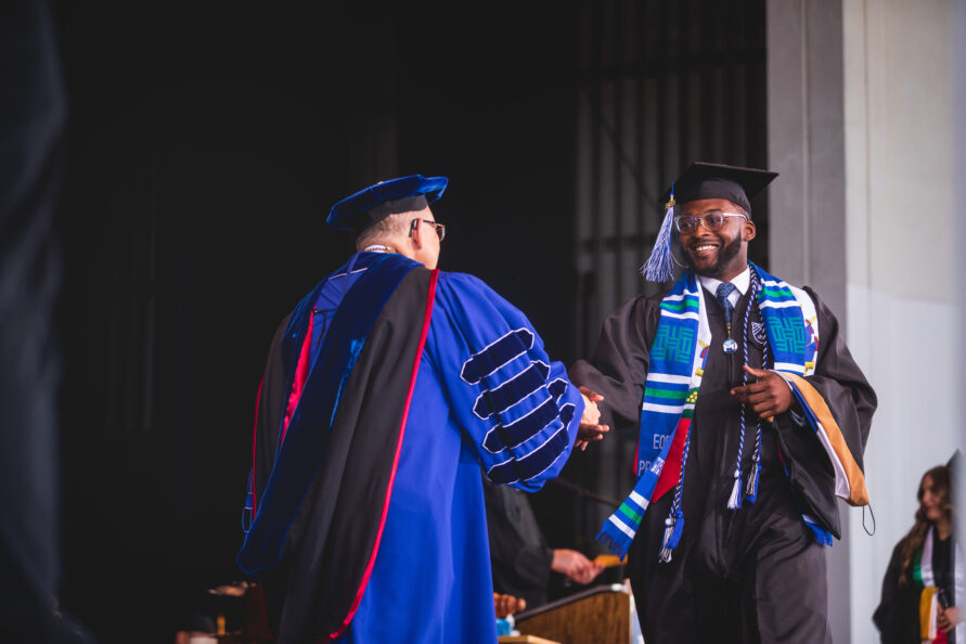graduate receiving degree on stage