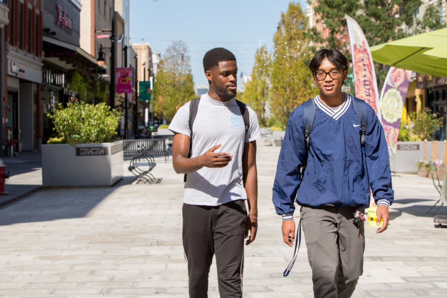 Two students walking in Jersey City.