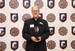 photo of Fr. James Miracky receiving award at Canisius High School