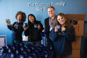 photo of staff handing out mugs on Jesuit Mission Day 2026