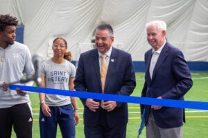 Dr. Benitez, Tom Mac Mahon and student athletes cutting the ribbon