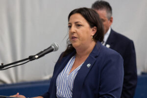 phot of Athletic Director Katie Arcuri speaking at the Yanitelli Bubble opening