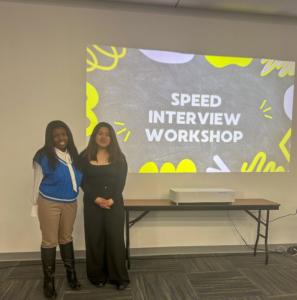 photo of 2 students in front of the TRIO speed interview workshop sign