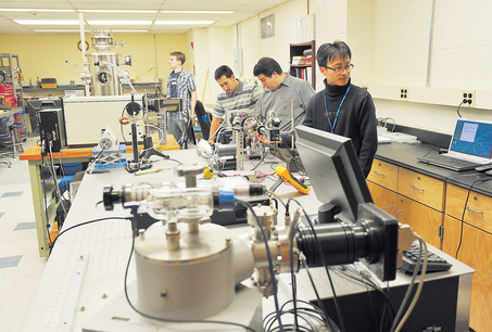 Dr. Weidong Zhu, Dr. Jose Lopez, students David Jacome and Brian McCullough inside the MicroElectronics and MicroPlasma Science Laboratory