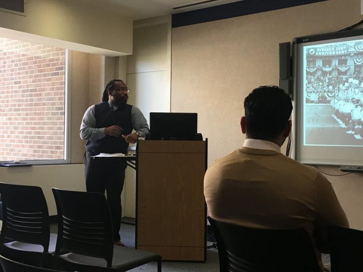 Dr. Johnson showing an image of Newark's 300th anniversary parade.