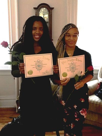 Brittanie Fils '19 and Giovana Burgess-Humes '20 pose with their certificates of induction.