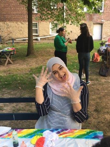 A student excitedly shows off her gloves